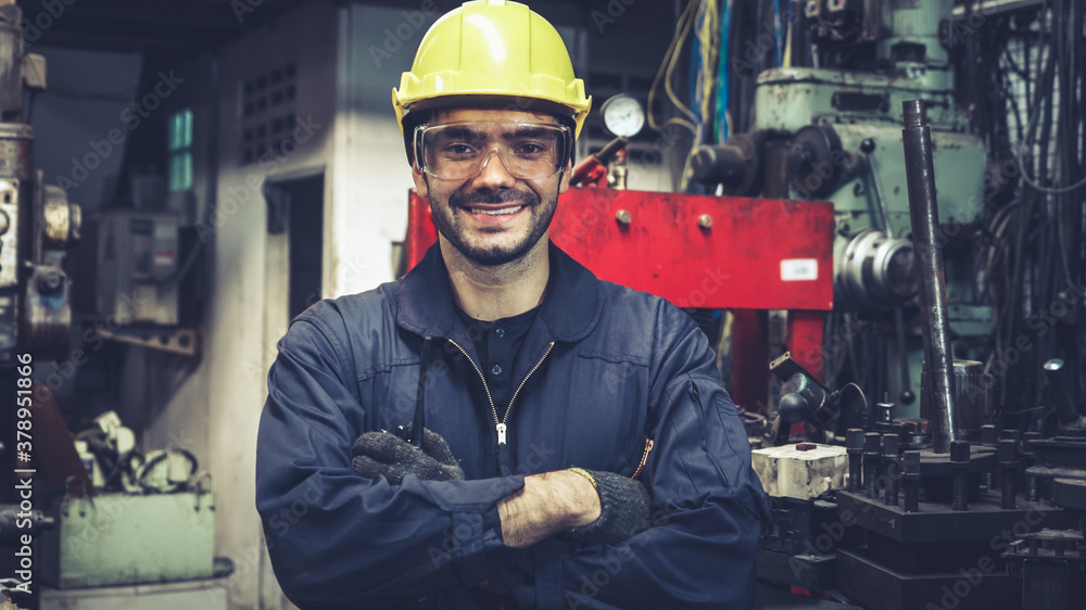 Young factory worker or engineer close up portrait in factory . Industry and engineering concept .