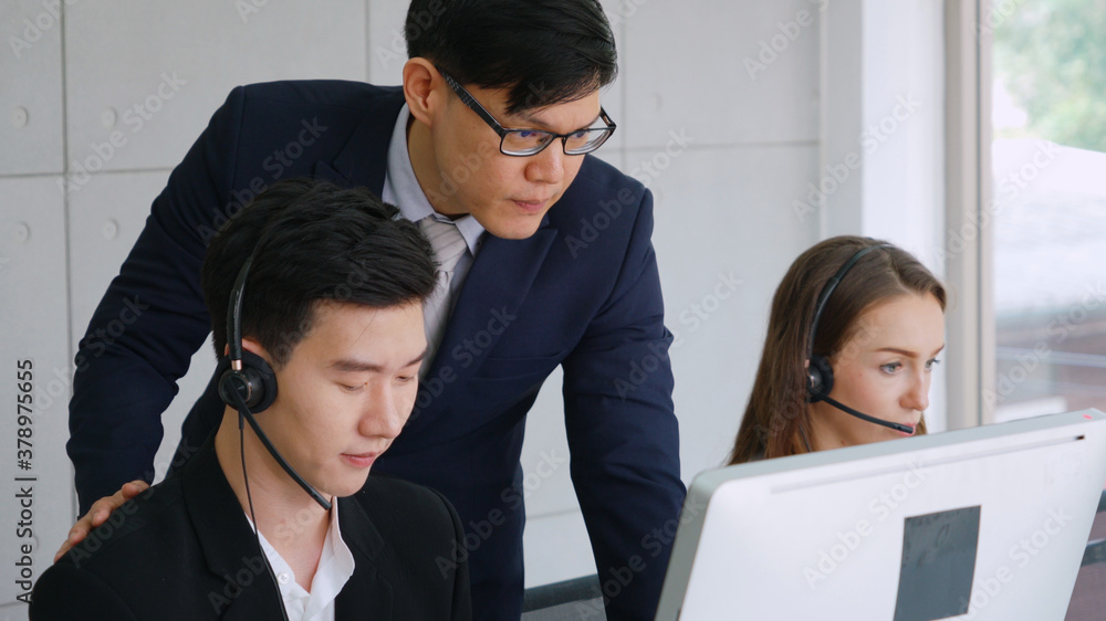 Business people wearing headset working in office to support remote customer or colleague. Call cent