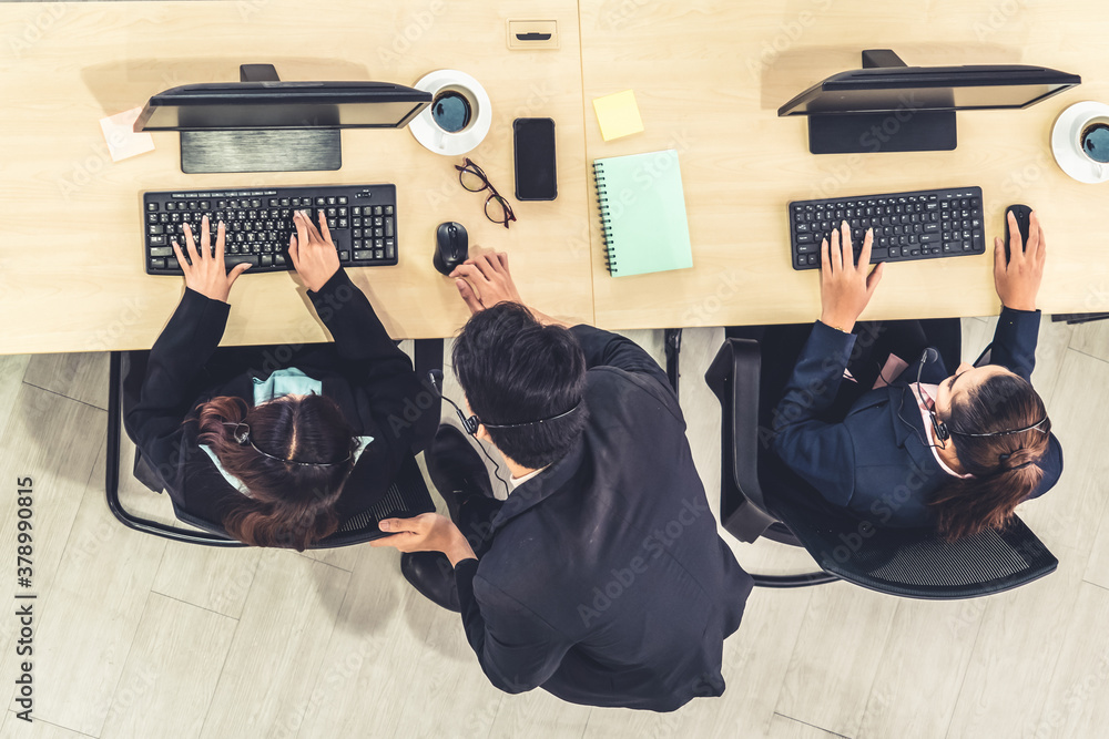 Business people wearing headset from top view in office working with computer to support remote cust