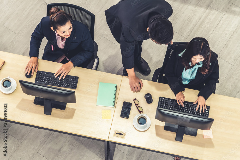 Business people wearing headset from top view in office working with computer to support remote cust