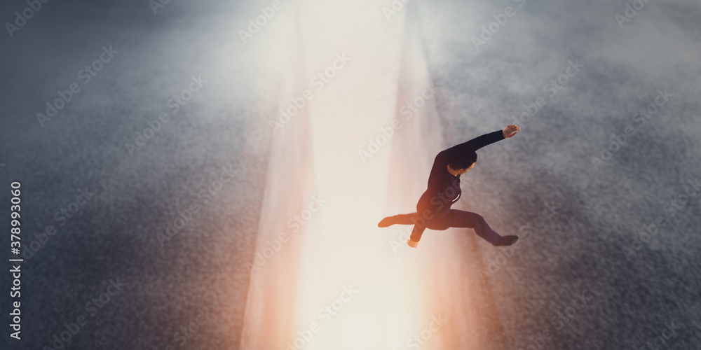 Businessman jumping over a precipice or gap.