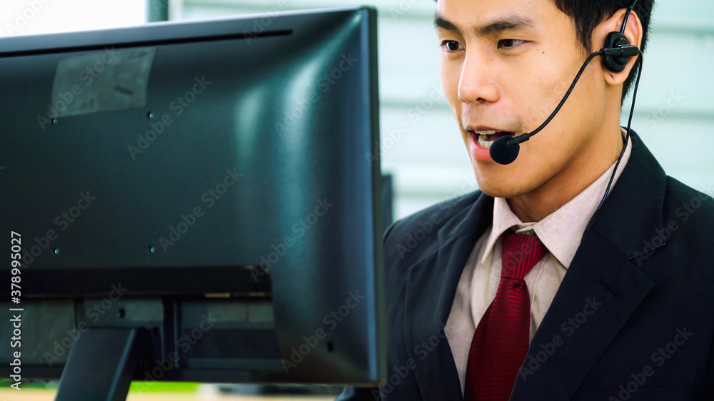 Business people wearing headset working in office to support remote customer or colleague. Call cent