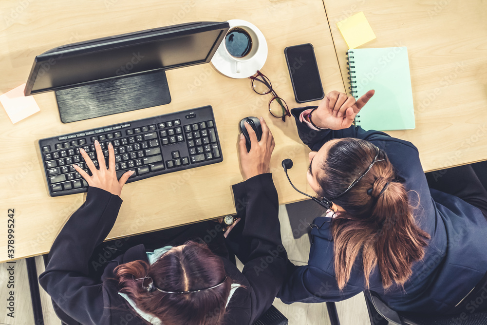 Business people wearing headset from top view in office working with computer to support remote cust