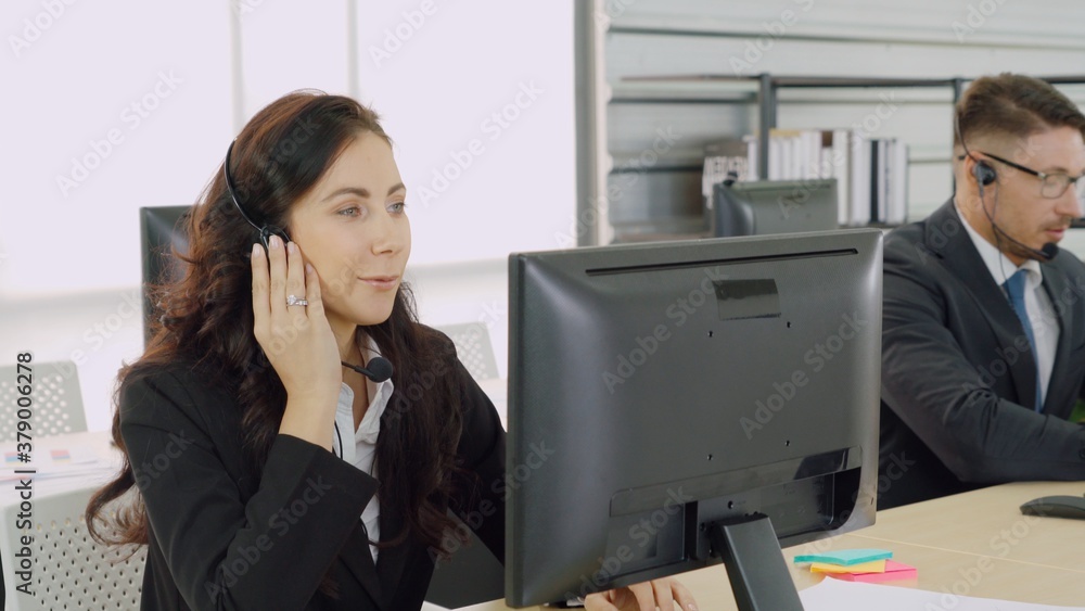 Business people wearing headset working in office to support remote customer or colleague. Call cent