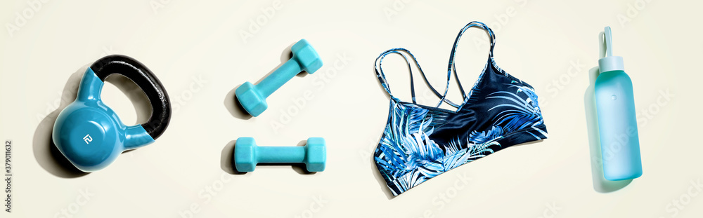 Fitness theme with dumbbells and a sportswear - flat lay