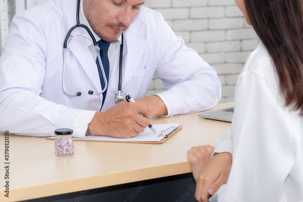 Doctor in professional uniform examining patient at hospital or medical clinic. Health care , medica