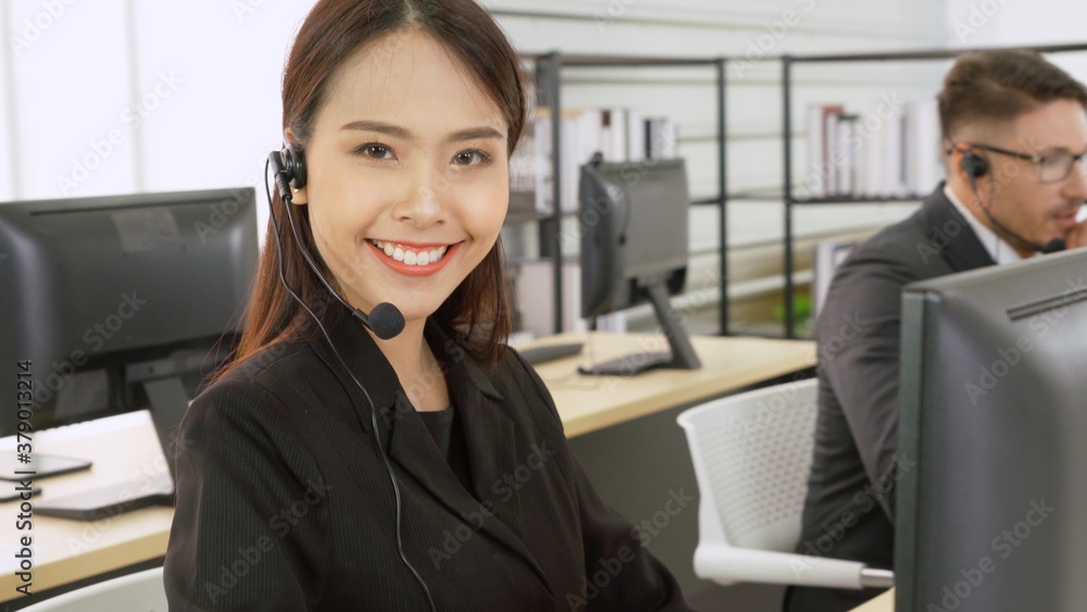 Business people wearing headset working in office to support remote customer or colleague. Call cent