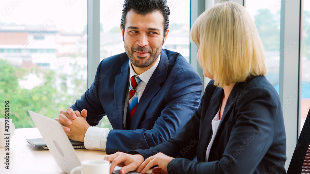 Two business people talk project strategy at office meeting room. Businessman discuss project planni