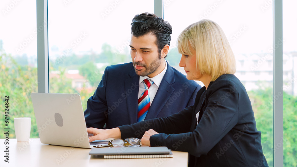 Two business people talk project strategy at office meeting room. Businessman discuss project planni