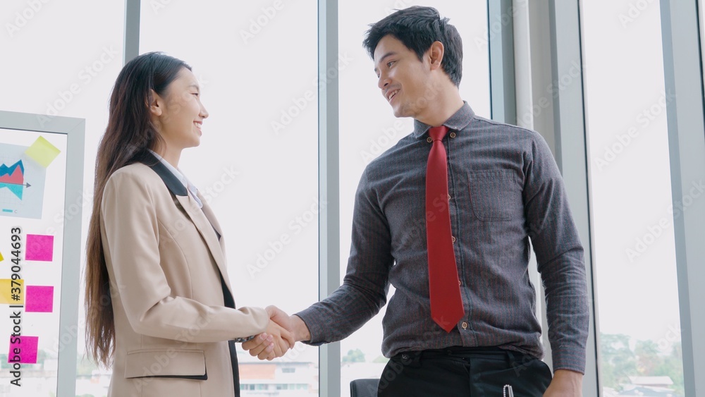 Business people handshake in corporate office showing professional agreement on a financial deal con