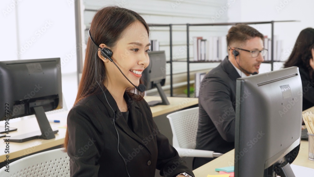 Business people wearing headset working in office to support remote customer or colleague. Call cent