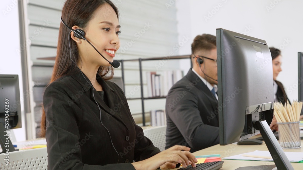 Business people wearing headset working in office to support remote customer or colleague. Call cent