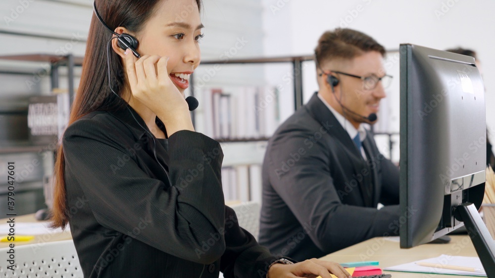 Business people wearing headset working in office to support remote customer or colleague. Call cent