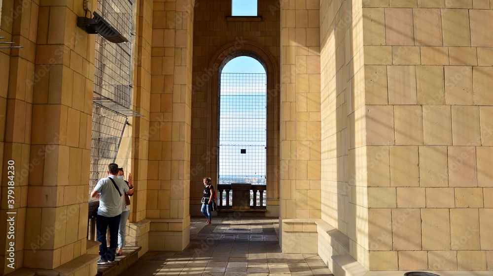 A lookout terrace on the 30th floor. People looking through barred windows on the terrace  located o