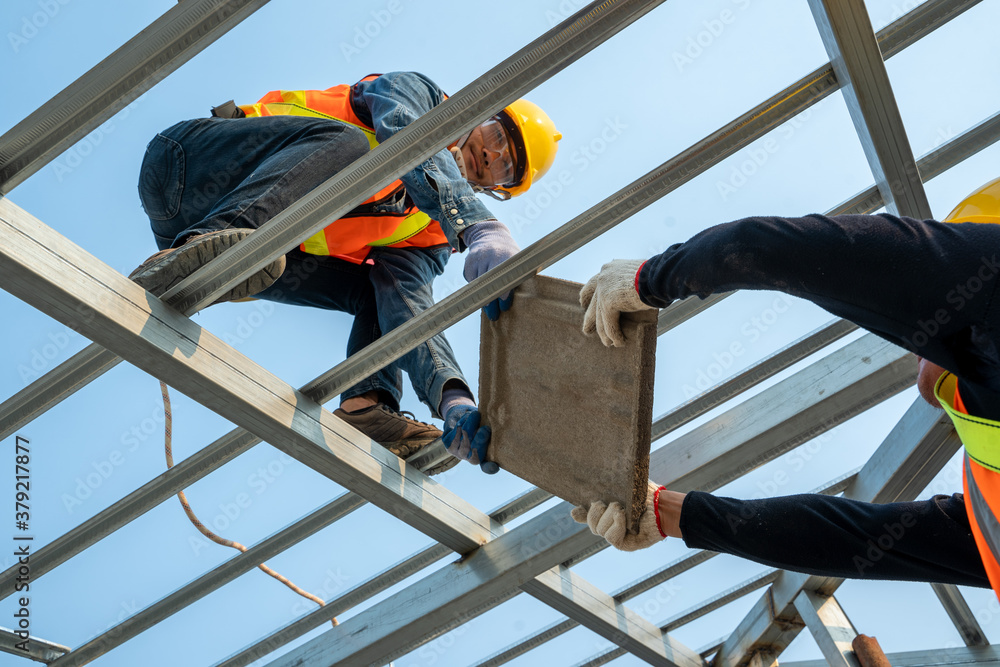 Ceramic Roof Tiles Installation by Roofer worker,Concept of residential building under construction.