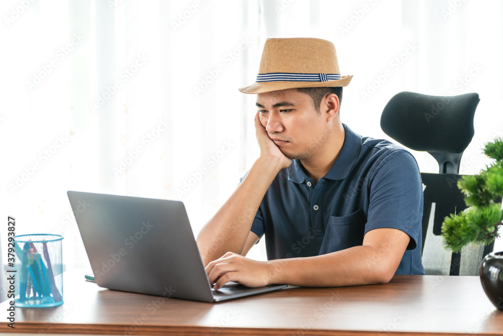 remote job, technology and people concept - stressed young asian man with laptop computer working at