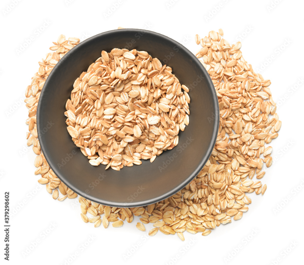 Bowl with raw oatmeal on white background