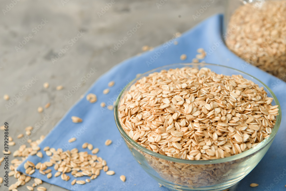 Bowl with raw oatmeal on table