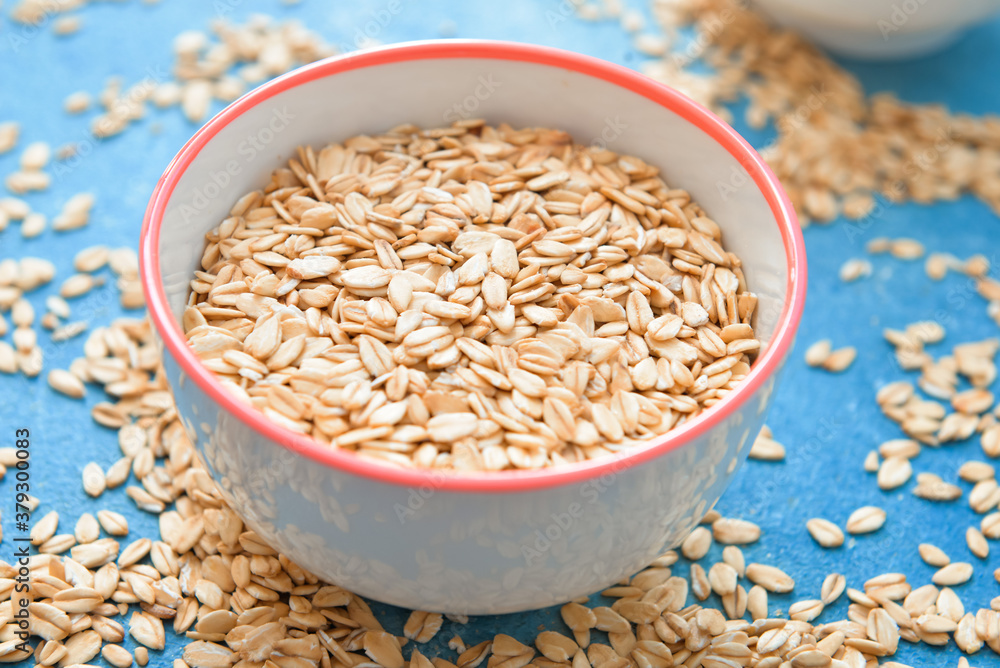 Bowl with raw oatmeal on table