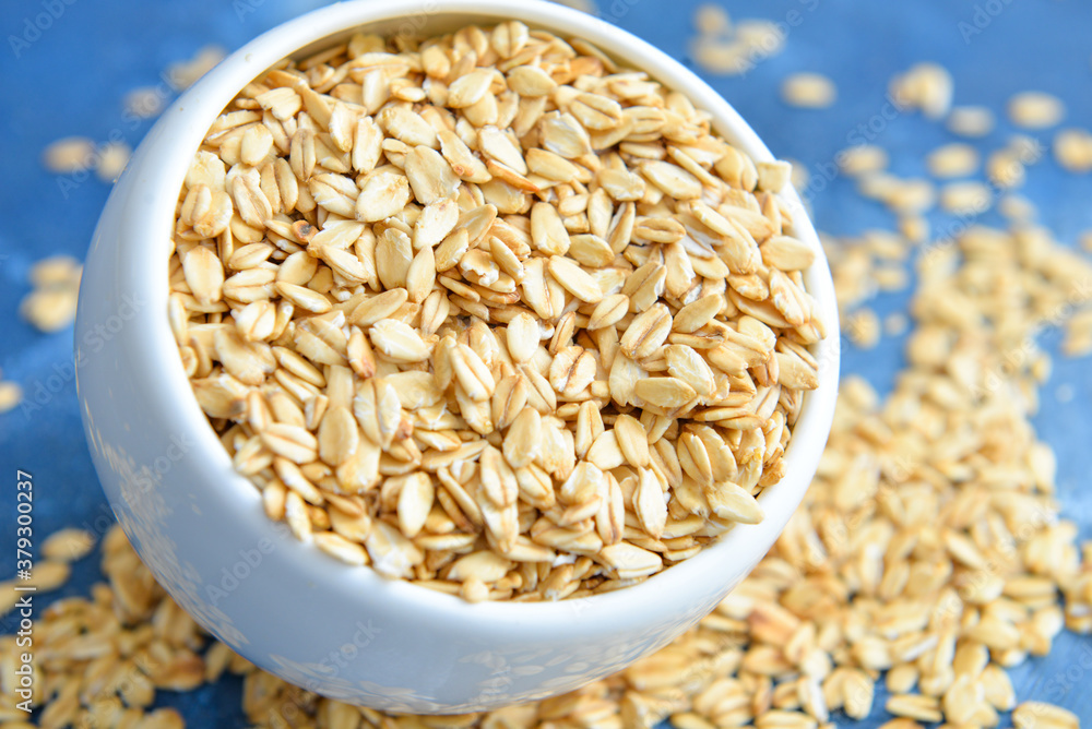 Bowl with raw oatmeal on table