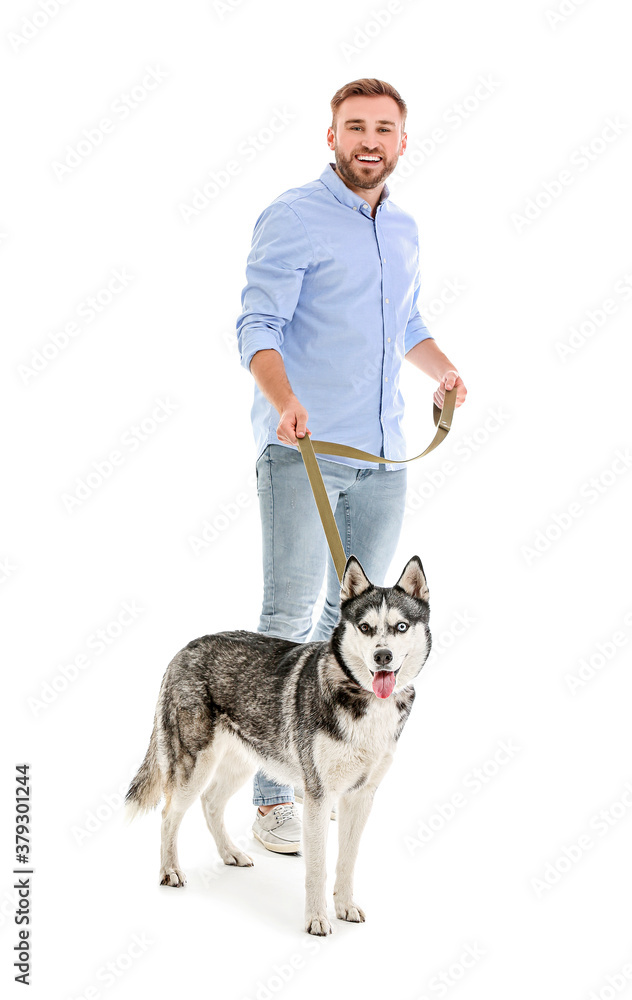 Young man with cute Husky dog on white background