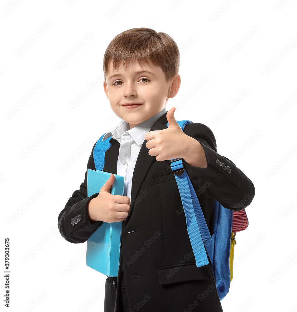 Little schoolboy showing thumb-up on white background