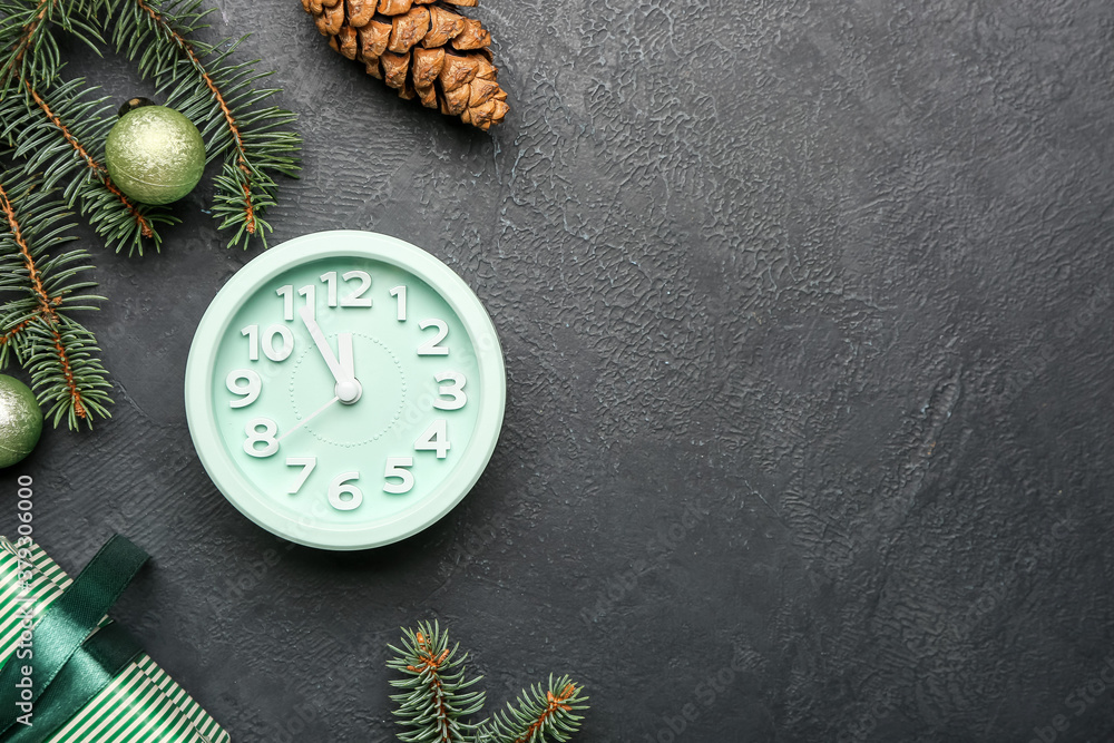 Clock and Christmas decor on grey background