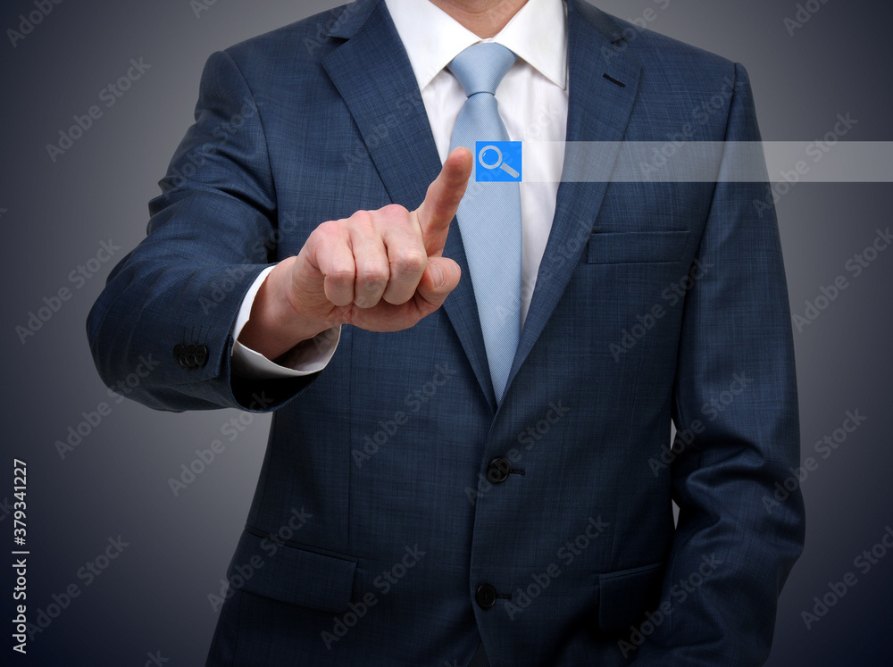 Businessman in suit touching virtual button