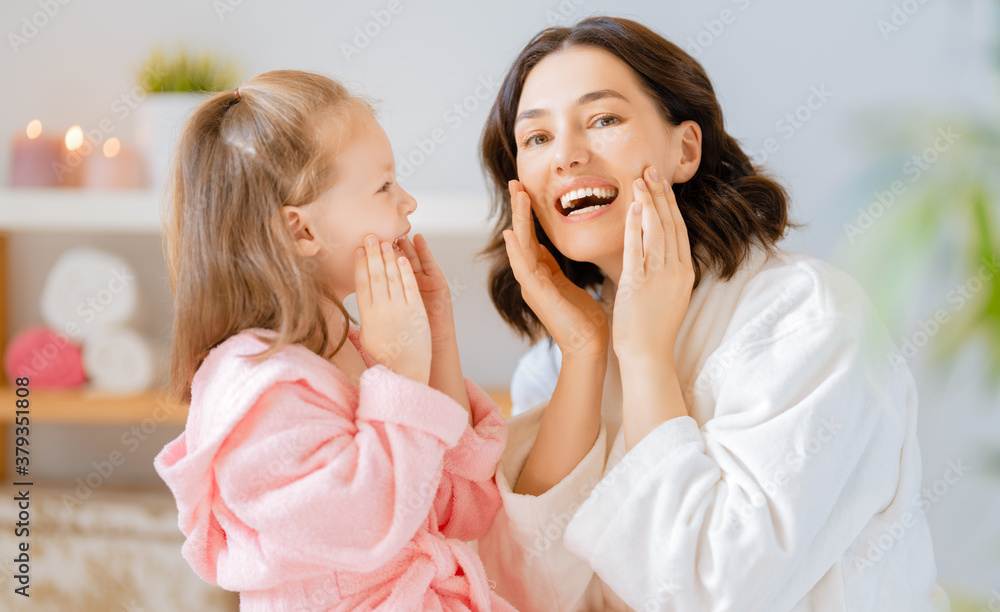 Mother and daughter caring for skin