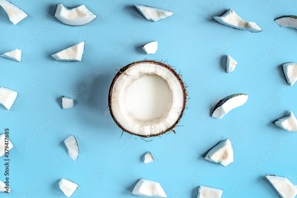 concept organic cosmetics with coconut on blue background top view