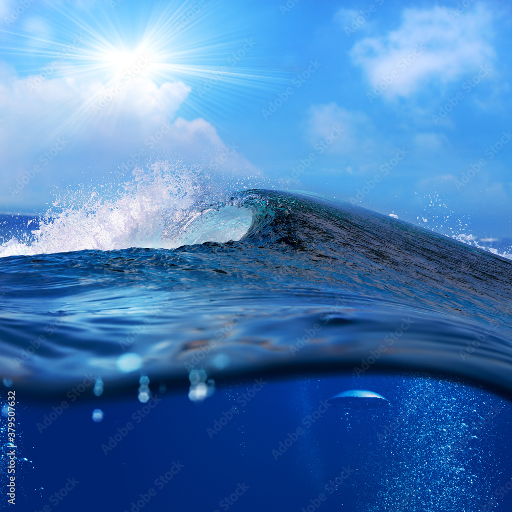 ocean-view seascape landscape Big surfing ocean wave with slightly cloudy sky and the sun