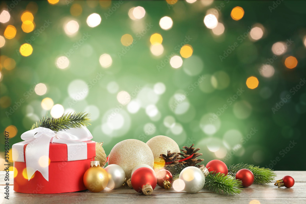 Beautiful Christmas composition on wooden table against color background with blurred lights