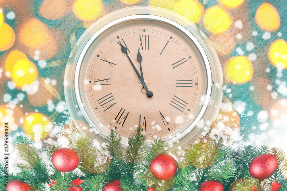 Clock, decor and snow against blurred lights. Christmas time