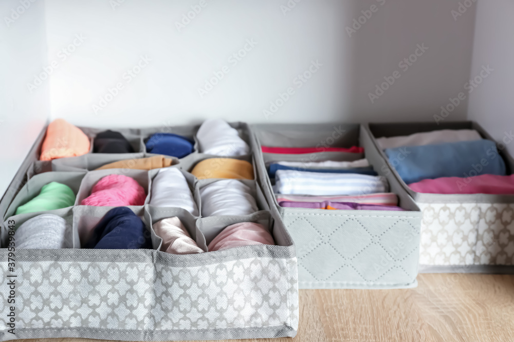 Organizers with clean clothes in closet