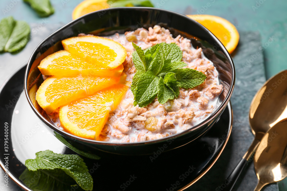 Bowl with tasty sweet oatmeal on table