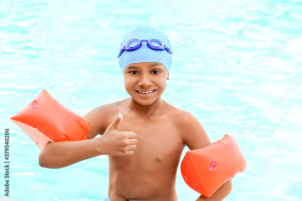 Cute African-American boy in swimming pool