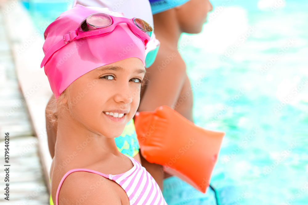 Cute little children near swimming pool