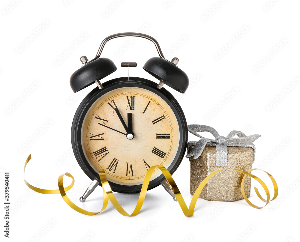 Alarm clock and Christmas gift on white background