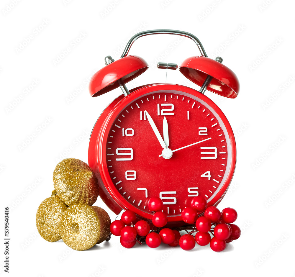 Alarm clock and Christmas decor on white background