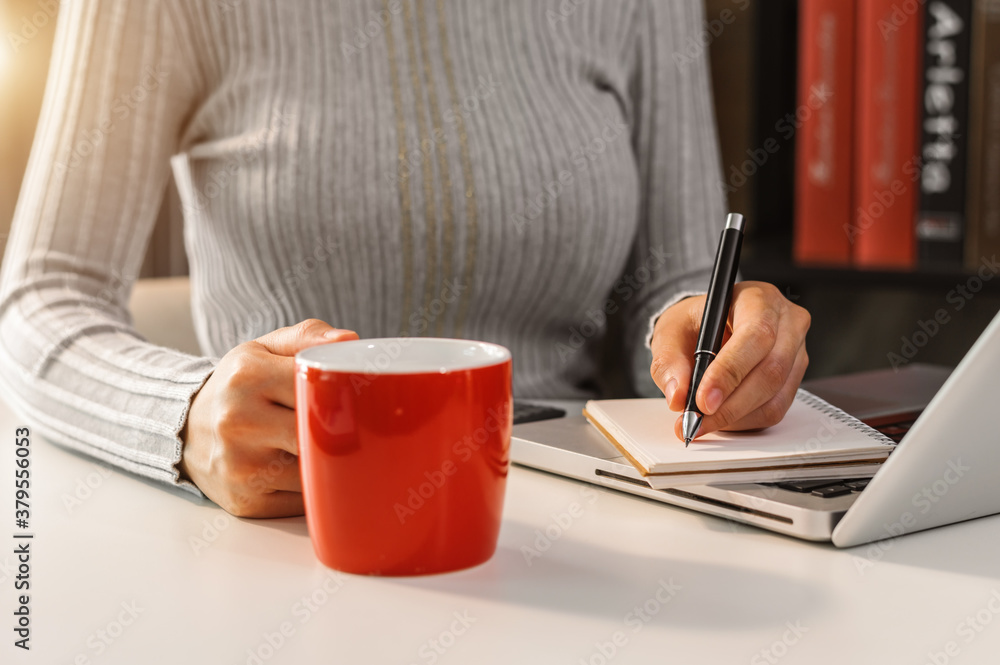 businessman hand working with new modern computer and writing on the notepad strategy diagram as con