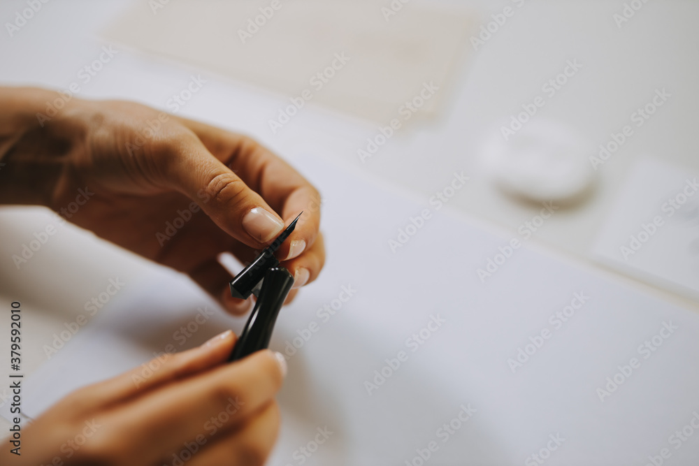 Artist holding fountain pen, changing metal nibs.