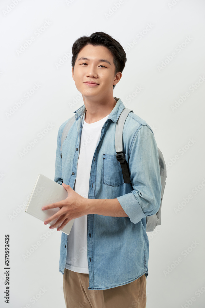 Smiling young man student in casual clothes with backpack isolated on white background studio portra