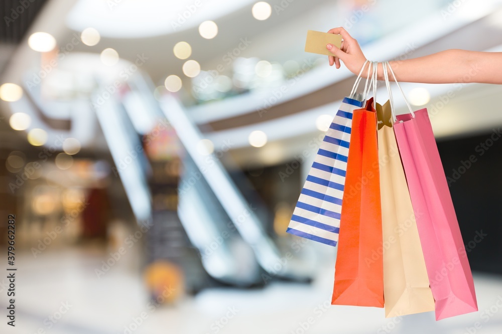 Woman hand with many shopping bags and credit card