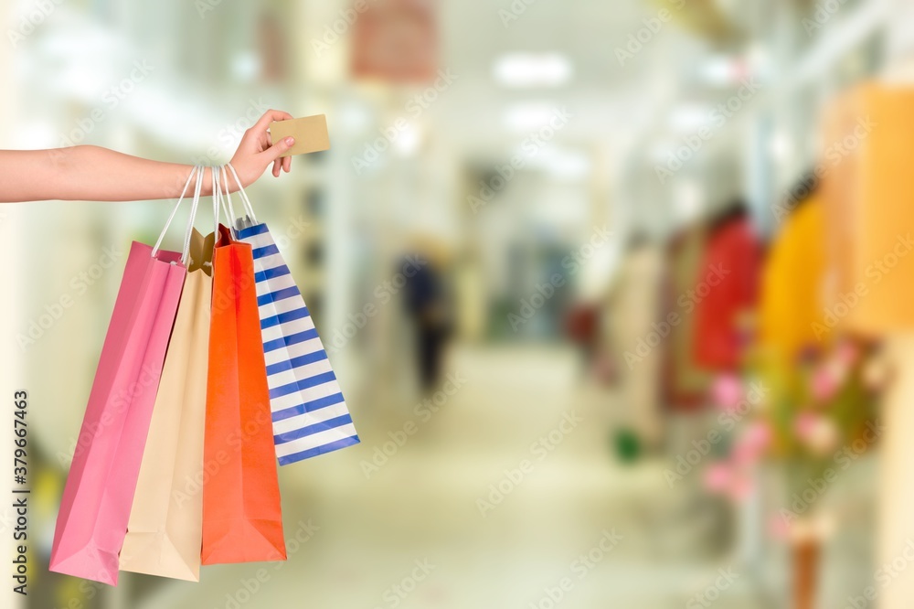 Woman hand with many shopping bags and credit card