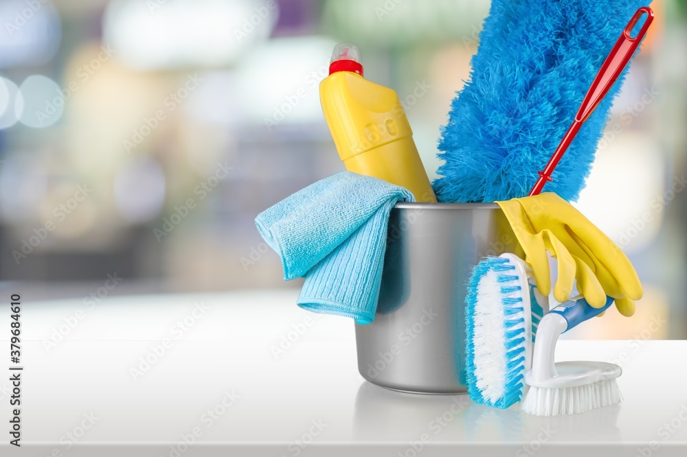 Plastic bottles, cleaning sponges and gloves in bucket