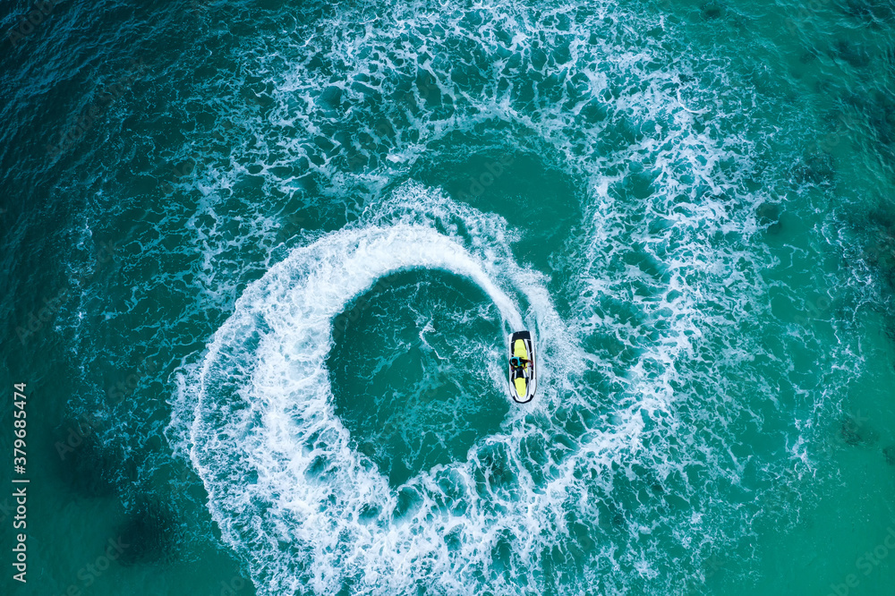 People are playing a jet ski in the sea.Aerial view. Top view.amazing nature background. The color o