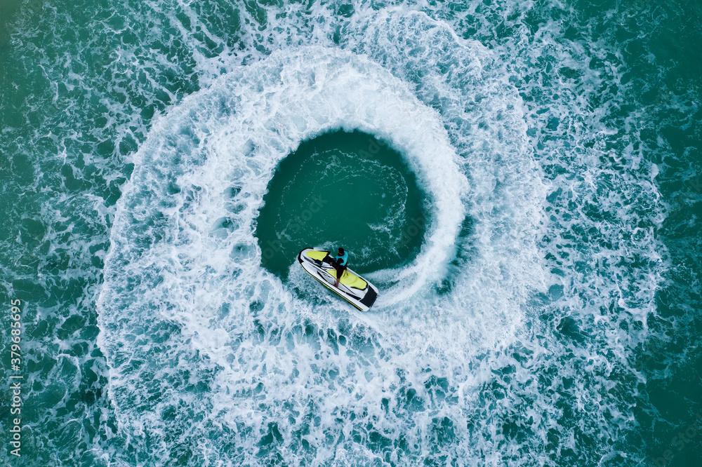 People are playing a jet ski in the sea.Aerial view. Top view.amazing nature background. The color o