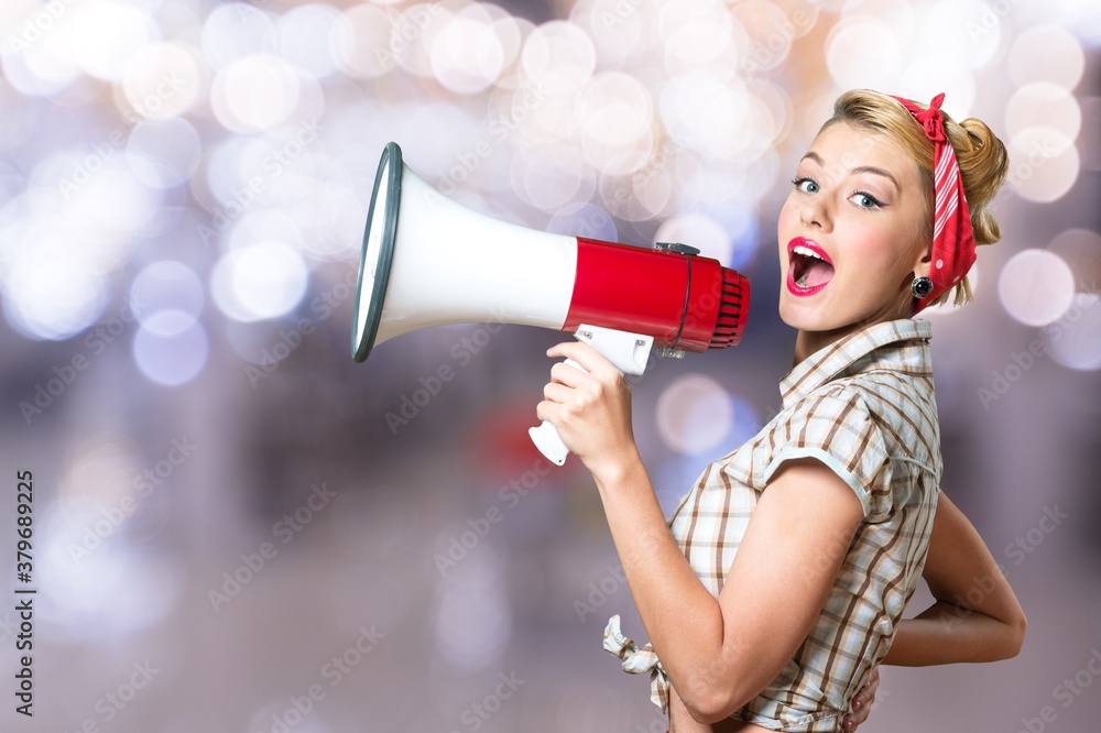 Beautiful woman holding megaphone and screams