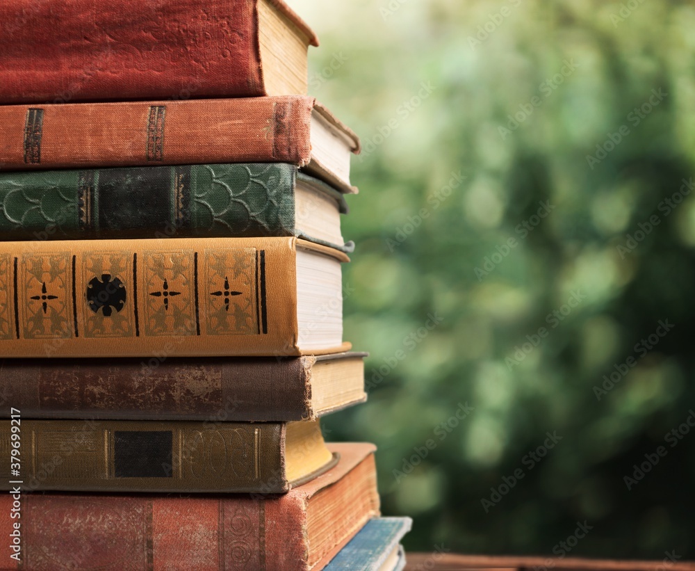 Collection of old books stack on blur background