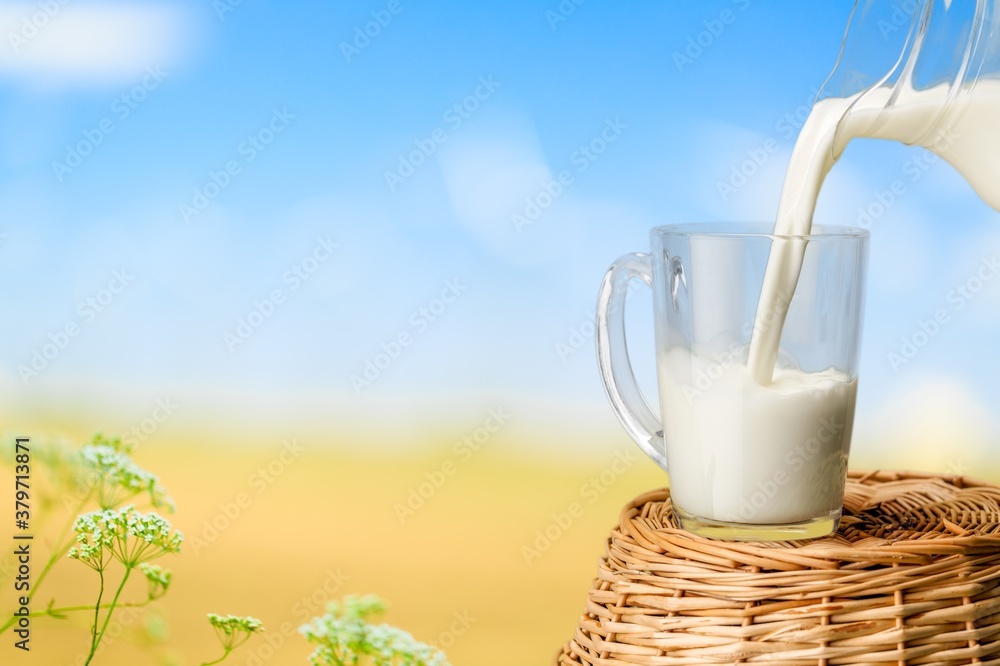 Glass of fresh milk on a natural background